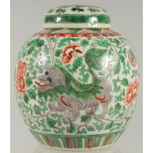 3 - A CHINESE FAMILLE VERTE PORCELAIN JAR AND COVER, painted with foo dogs and large flower heads amongs... 