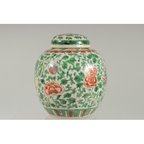 3 - A CHINESE FAMILLE VERTE PORCELAIN JAR AND COVER, painted with foo dogs and large flower heads amongs... 