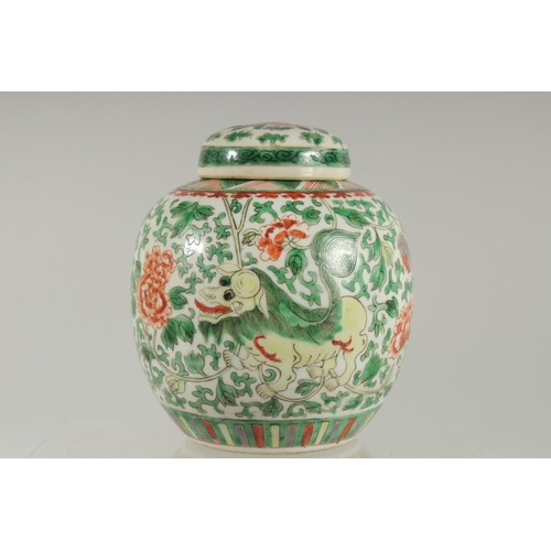 3 - A CHINESE FAMILLE VERTE PORCELAIN JAR AND COVER, painted with foo dogs and large flower heads amongs... 