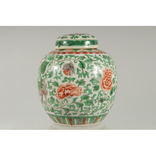 3 - A CHINESE FAMILLE VERTE PORCELAIN JAR AND COVER, painted with foo dogs and large flower heads amongs... 