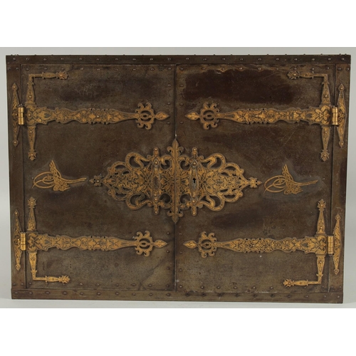 304 - A FINE QAJAR GOLD DAMASCENED STEEL OVERLAID WOODEN TABLE CABINET, with gold inlaid tughra to the doo... 