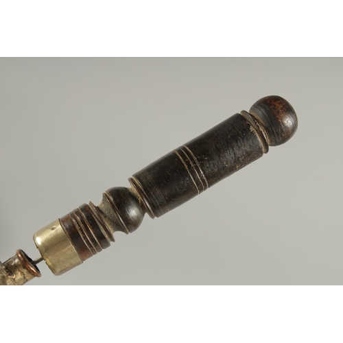 312 - A TIBETAN EMBOSSED SILVER PRAYER WHEEL CONTAINING SCROLL, 27cm long.