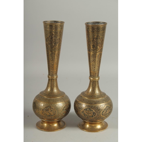 313 - A PAIR OF QAJAR ENGRAVED BRASS BOTTLE VASES, decorated with various panels of birds and flora, 28cm ... 