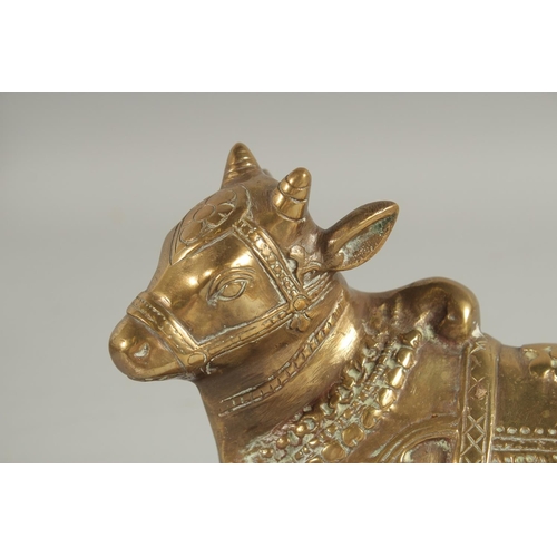 314 - A GILDED BRONZE FIGURE OF NANDI, 21cm long.