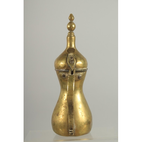 315 - A STAMPED ISLAMIC BRASS COFFEE POT, 27cm high.