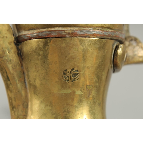 315 - A STAMPED ISLAMIC BRASS COFFEE POT, 27cm high.