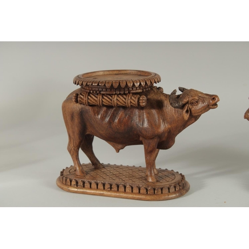 343 - TWO FINE 19TH CENTURY ANGLO INDIAN CARVED WOODEN BUFFALO SHAPED COASTERS / STANDS, each approx. 24cm... 