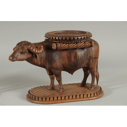 343 - TWO FINE 19TH CENTURY ANGLO INDIAN CARVED WOODEN BUFFALO SHAPED COASTERS / STANDS, each approx. 24cm... 