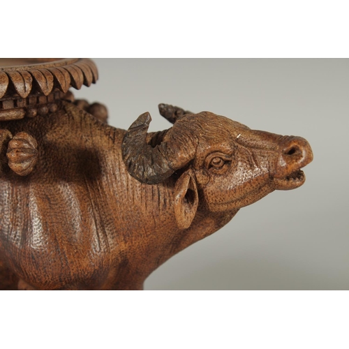 343 - TWO FINE 19TH CENTURY ANGLO INDIAN CARVED WOODEN BUFFALO SHAPED COASTERS / STANDS, each approx. 24cm... 