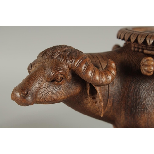 343 - TWO FINE 19TH CENTURY ANGLO INDIAN CARVED WOODEN BUFFALO SHAPED COASTERS / STANDS, each approx. 24cm... 