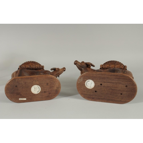 343 - TWO FINE 19TH CENTURY ANGLO INDIAN CARVED WOODEN BUFFALO SHAPED COASTERS / STANDS, each approx. 24cm... 