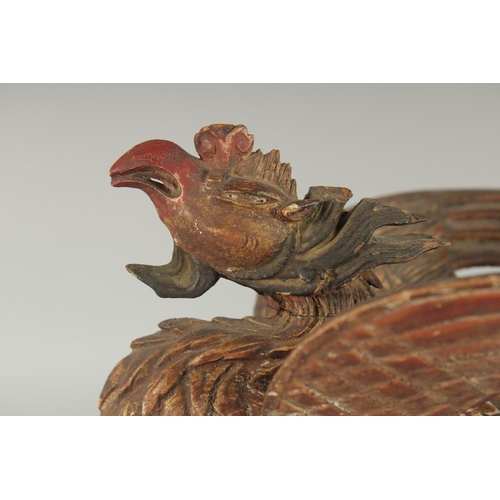 348 - AN 18TH-19TH CENTURY SOUTH EAST ASIAN LACQUERED CARVED WOODEN PHOENIX, possibly Thai, 30cm long.