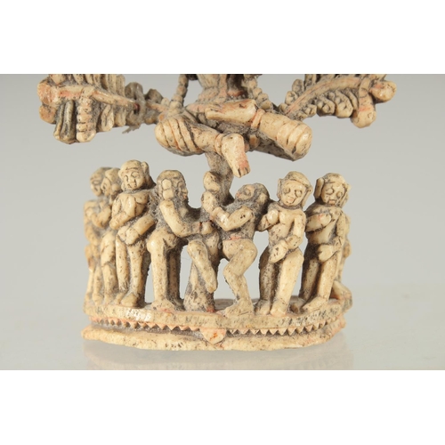 349 - A FINE 17TH-18TH CENTURY SOUTH INDIAN CARVED BONE FLUTING KRISHNA UNDER TREE, 10.5cm high.