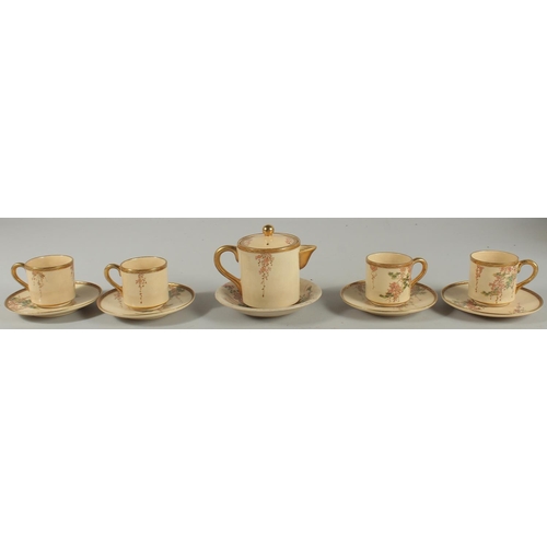 36 - A JAPANESE SATSUMA TEA SET, comprising a teapot, four cups and saucers, together with an associated ... 