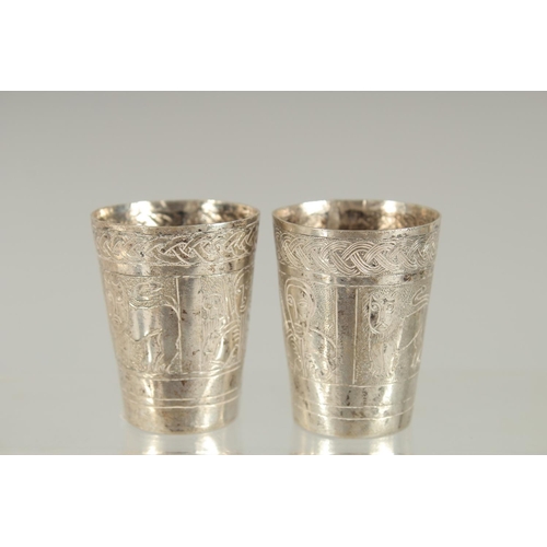 365 - TWO SMALL ETHIOPIAN SILVER CUPS, with engraved decoration, 4.5cm high.