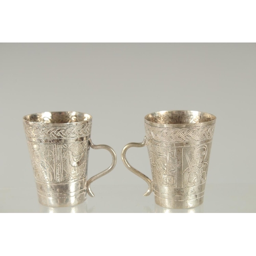 365 - TWO SMALL ETHIOPIAN SILVER CUPS, with engraved decoration, 4.5cm high.