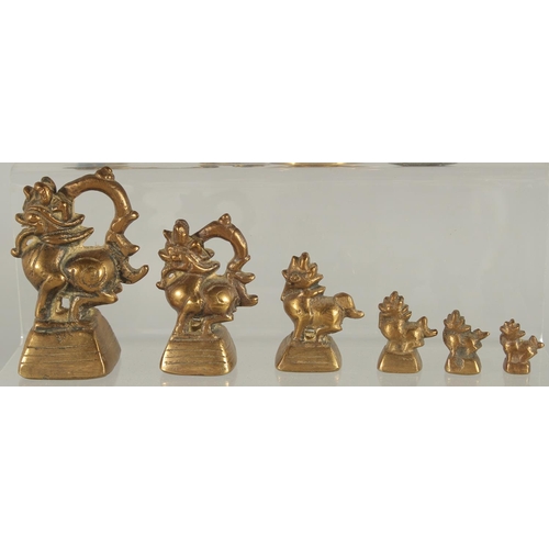 369 - A COLLECTION OF SEVEN BRASS OPIUM WEIGHTS, together with four other brass items, (11).