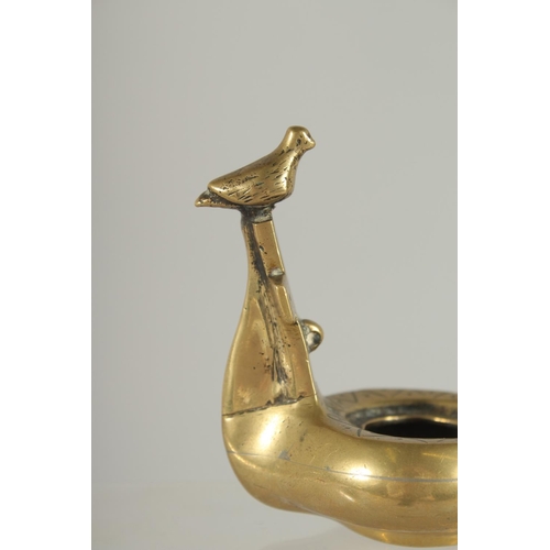 370 - A ROMAN / GREEK STYLE BRASS OIL LAMP, 10.5cm long.