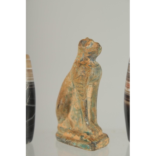 371 - AN EGYPTIAN CARVED STONE CAT, together with three large banded agate beads, (4).