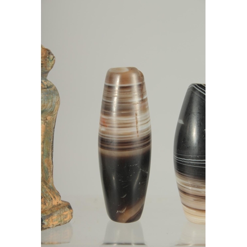 371 - AN EGYPTIAN CARVED STONE CAT, together with three large banded agate beads, (4).