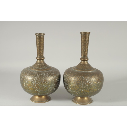 375 - A PAIR OF INDIAN ENGRAVED AND CHASED BRASS VASES, 28cm high.