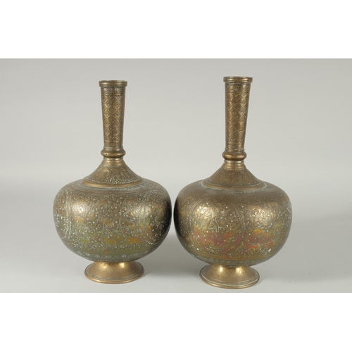 375 - A PAIR OF INDIAN ENGRAVED AND CHASED BRASS VASES, 28cm high.