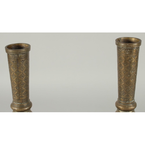 375 - A PAIR OF INDIAN ENGRAVED AND CHASED BRASS VASES, 28cm high.