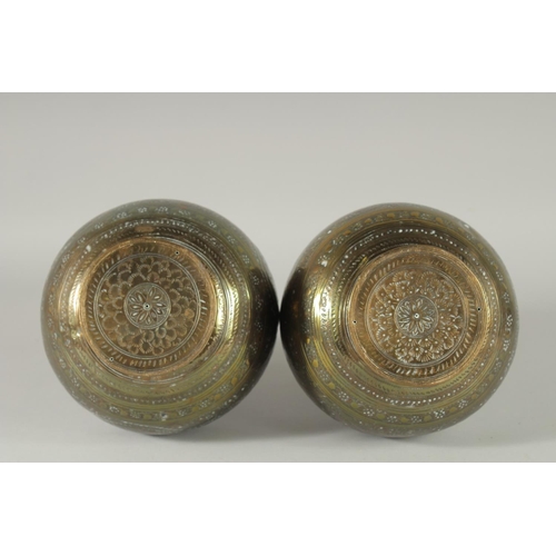 375 - A PAIR OF INDIAN ENGRAVED AND CHASED BRASS VASES, 28cm high.