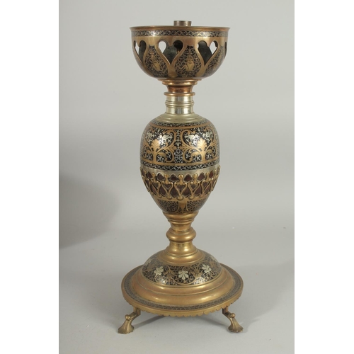 382 - AN UNUSUAL MIXED METAL ENAMELLED BRASS LAMP, with central brass overlaid coconut, the circular base ... 