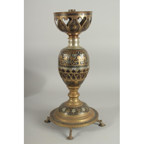 382 - AN UNUSUAL MIXED METAL ENAMELLED BRASS LAMP, with central brass overlaid coconut, the circular base ... 