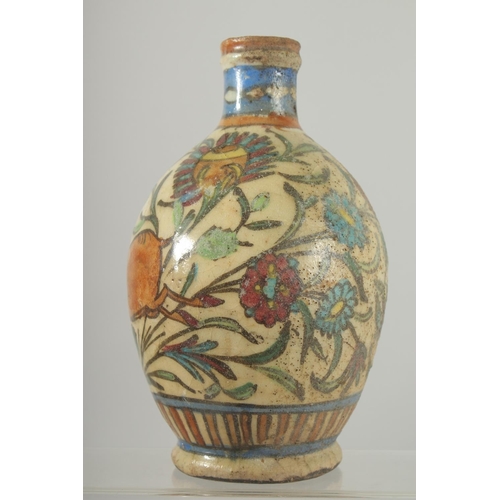 383 - AN IZNIK GLAZED POTTERY BOTTLE VASE, painted with a deer and flora, 21cm high.