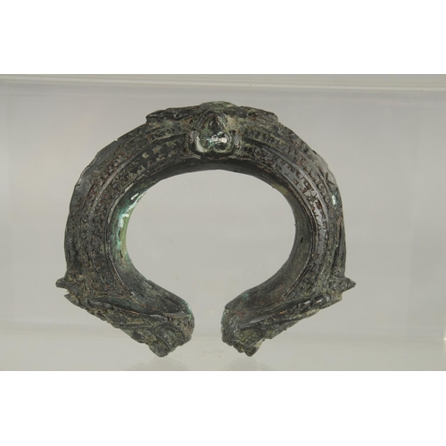 385 - AN ARCHAIC BRASS BANGLE.