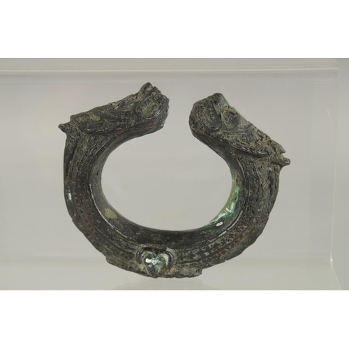 385 - AN ARCHAIC BRASS BANGLE.