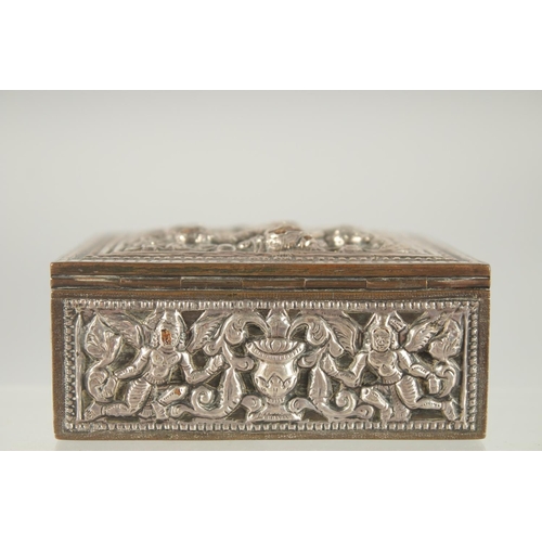 387 - AN INDIAN SILVER OVERLAID SQUARE BOX, with hinged lid and relief decoration, 8cm square.