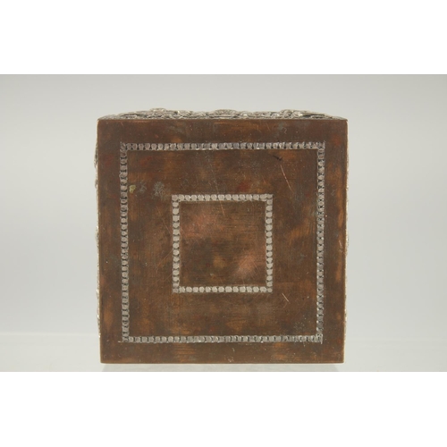 387 - AN INDIAN SILVER OVERLAID SQUARE BOX, with hinged lid and relief decoration, 8cm square.