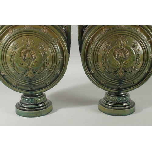 390 - A PAIR OF 19TH CENTURY GREEN HISPANO-MORESQUE GLAZED CERAMIC CANDLESTICKS / VASES, 60cm high.