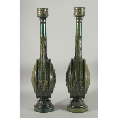 390 - A PAIR OF 19TH CENTURY GREEN HISPANO-MORESQUE GLAZED CERAMIC CANDLESTICKS / VASES, 60cm high.