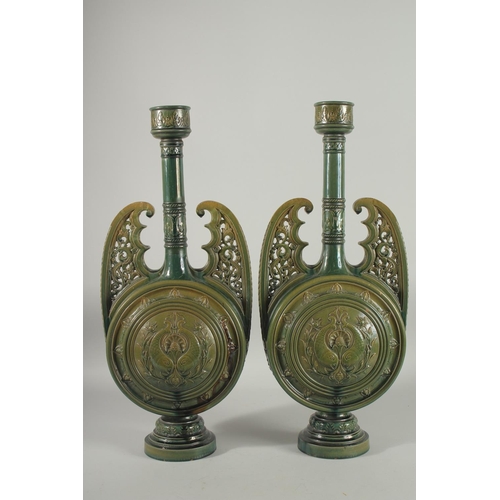 390 - A PAIR OF 19TH CENTURY GREEN HISPANO-MORESQUE GLAZED CERAMIC CANDLESTICKS / VASES, 60cm high.