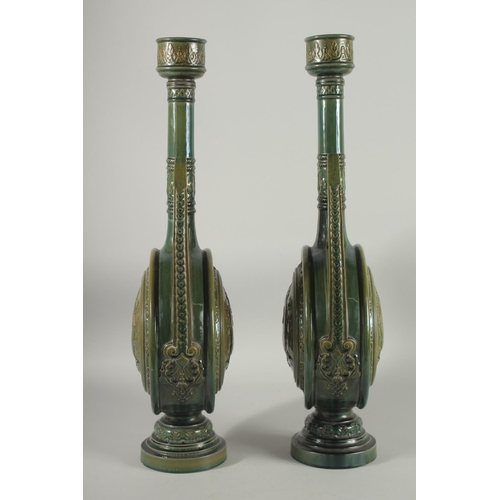 390 - A PAIR OF 19TH CENTURY GREEN HISPANO-MORESQUE GLAZED CERAMIC CANDLESTICKS / VASES, 60cm high.