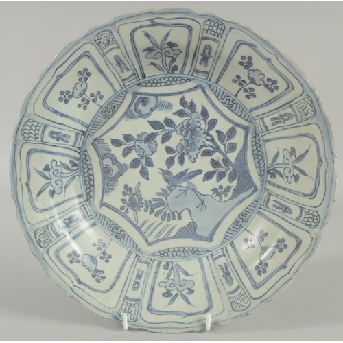 4 - AN 18TH CENTURY NANKING CARGO BLUE AND WHITE DISH, decorated with a central panel of a bird and flor... 