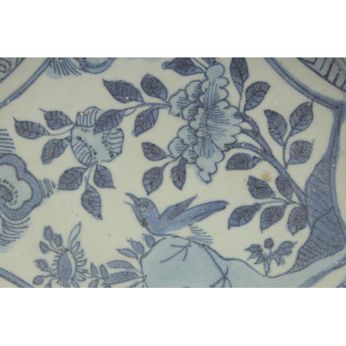 4 - AN 18TH CENTURY NANKING CARGO BLUE AND WHITE DISH, decorated with a central panel of a bird and flor... 