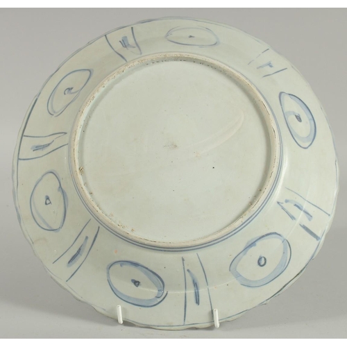 4 - AN 18TH CENTURY NANKING CARGO BLUE AND WHITE DISH, decorated with a central panel of a bird and flor... 