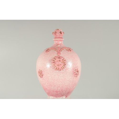 413 - AN ISLAMIC MARKET PINK PORCELAIN VESSEL, with moulded decoration and gilt highlights, 20.5cm high.