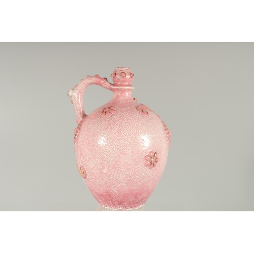 413 - AN ISLAMIC MARKET PINK PORCELAIN VESSEL, with moulded decoration and gilt highlights, 20.5cm high.