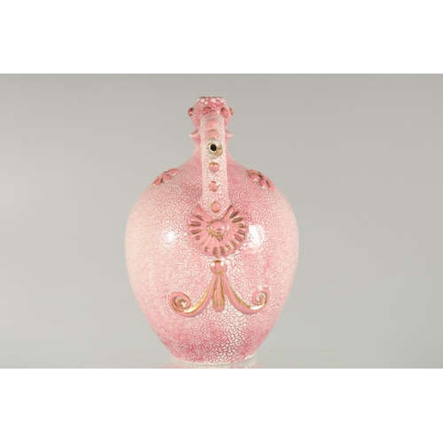 413 - AN ISLAMIC MARKET PINK PORCELAIN VESSEL, with moulded decoration and gilt highlights, 20.5cm high.