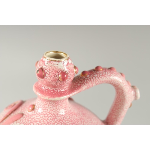 413 - AN ISLAMIC MARKET PINK PORCELAIN VESSEL, with moulded decoration and gilt highlights, 20.5cm high.