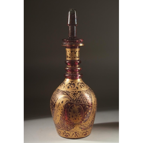 418 - A LARGE BOHEMIAN GLASS BOTTLE AND STOPPER, the body with decorative gilded motifs, 48cm high.