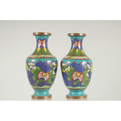 47 - A PAIR OF CHINESE BLUE GROUND CLOISONNE VASES, with floral decoration, 16cm high.