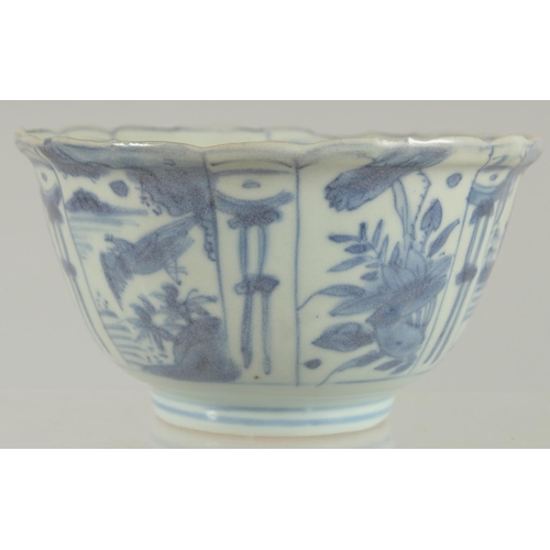 5 - AN 18TH CENTURY NANKING CARGO BLUE AND WHITE PORCELAIN BOWL, decorated with panels of flora and bird... 