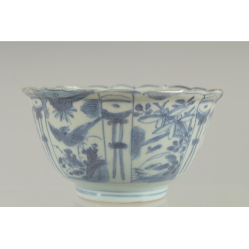 5 - AN 18TH CENTURY NANKING CARGO BLUE AND WHITE PORCELAIN BOWL, decorated with panels of flora and bird... 